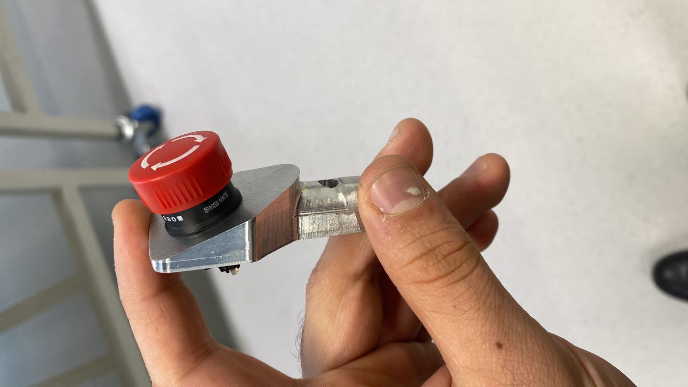 Fully manufactured Brake Over-Travel Switch mount held in hand